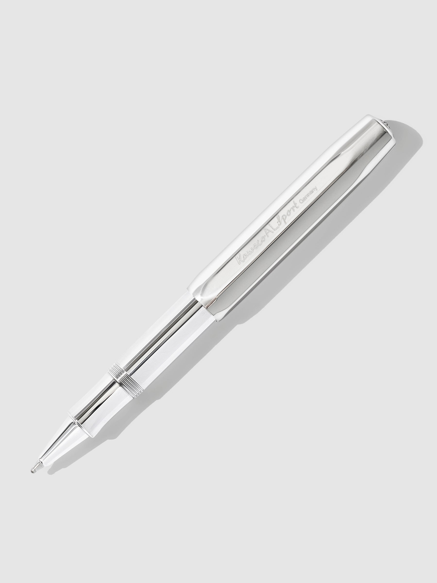Kaweco AL Sport Rollerball Pen, Raw Aluminum, Cloth and Paper. Kaweco pen displayed on a neutral background. The pen's nib is exposed.