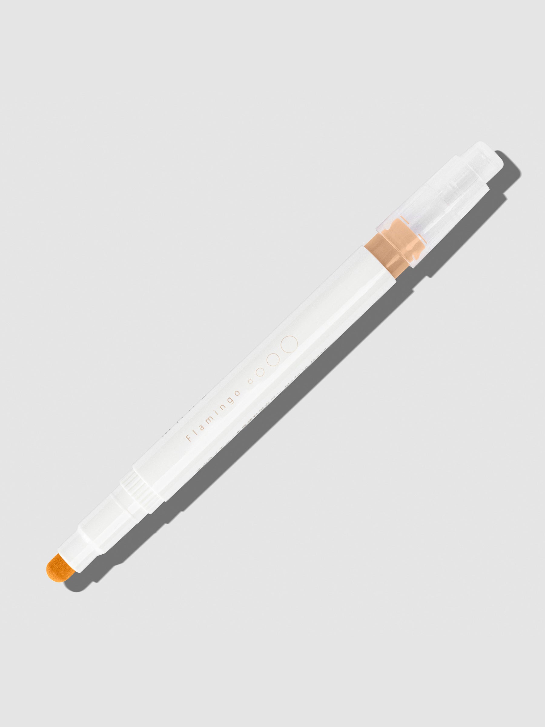 Flamingo highlighter with tip exposed and cap posted to the end of its barrel on a neutral background.