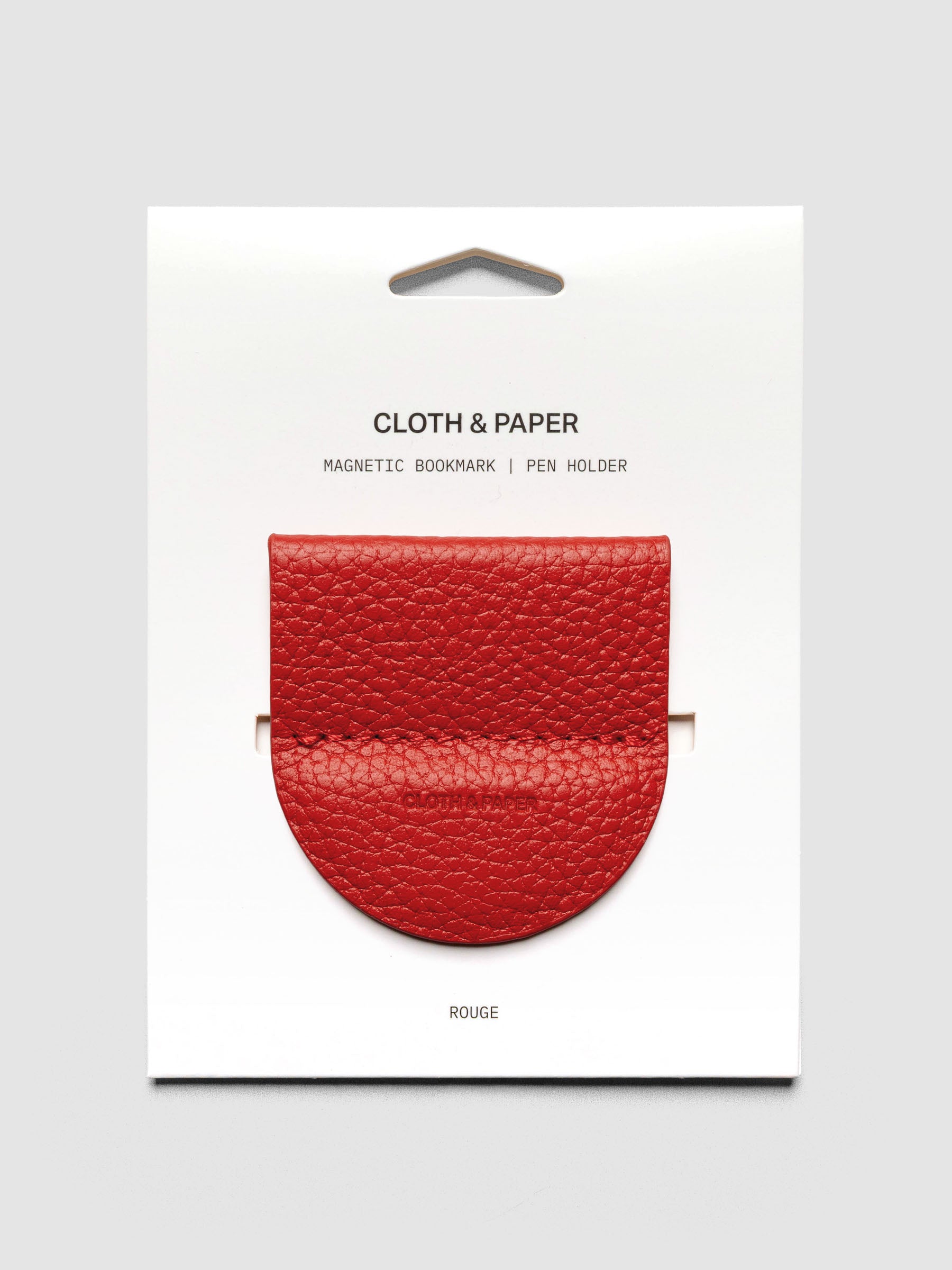 Rouge pen holder clip on a white backer card.