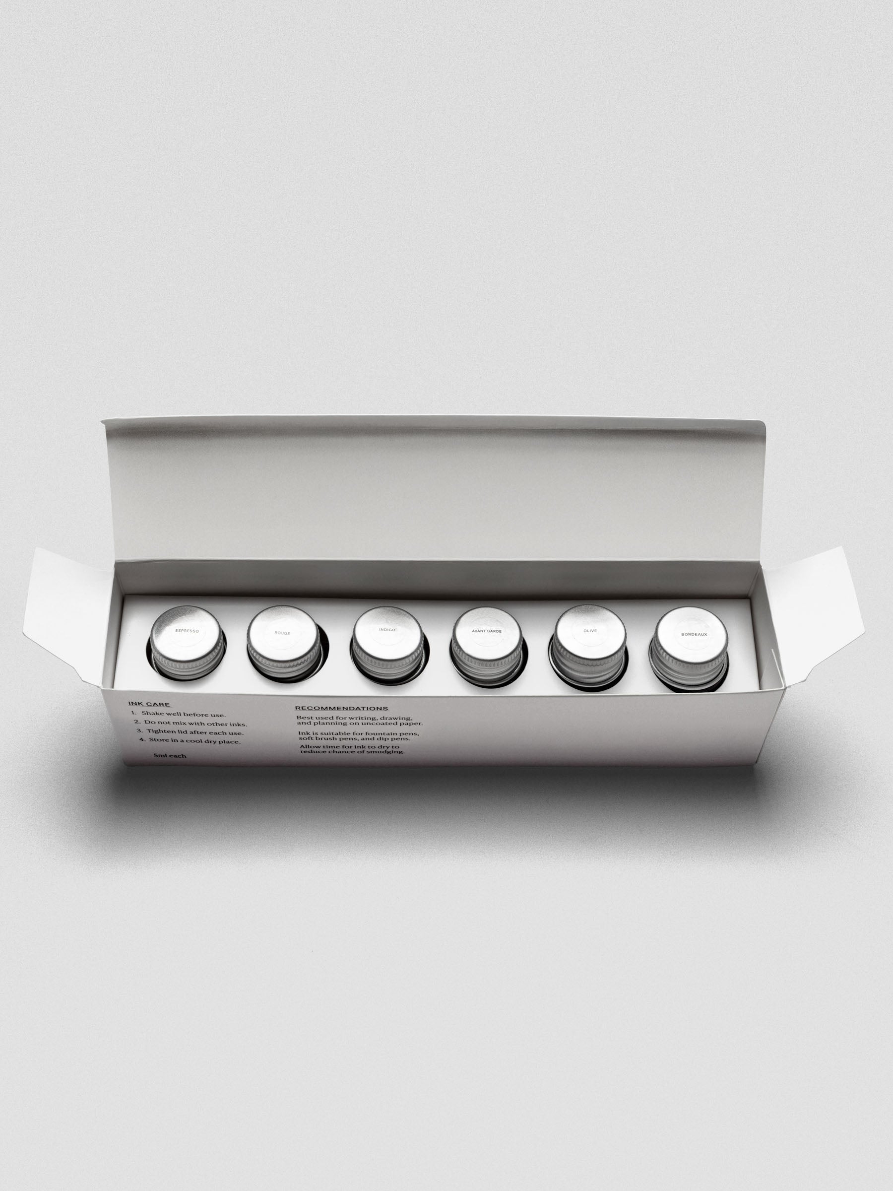 Set of six miniature bottles of fountain pen ink in six unique colors shown in packaging.