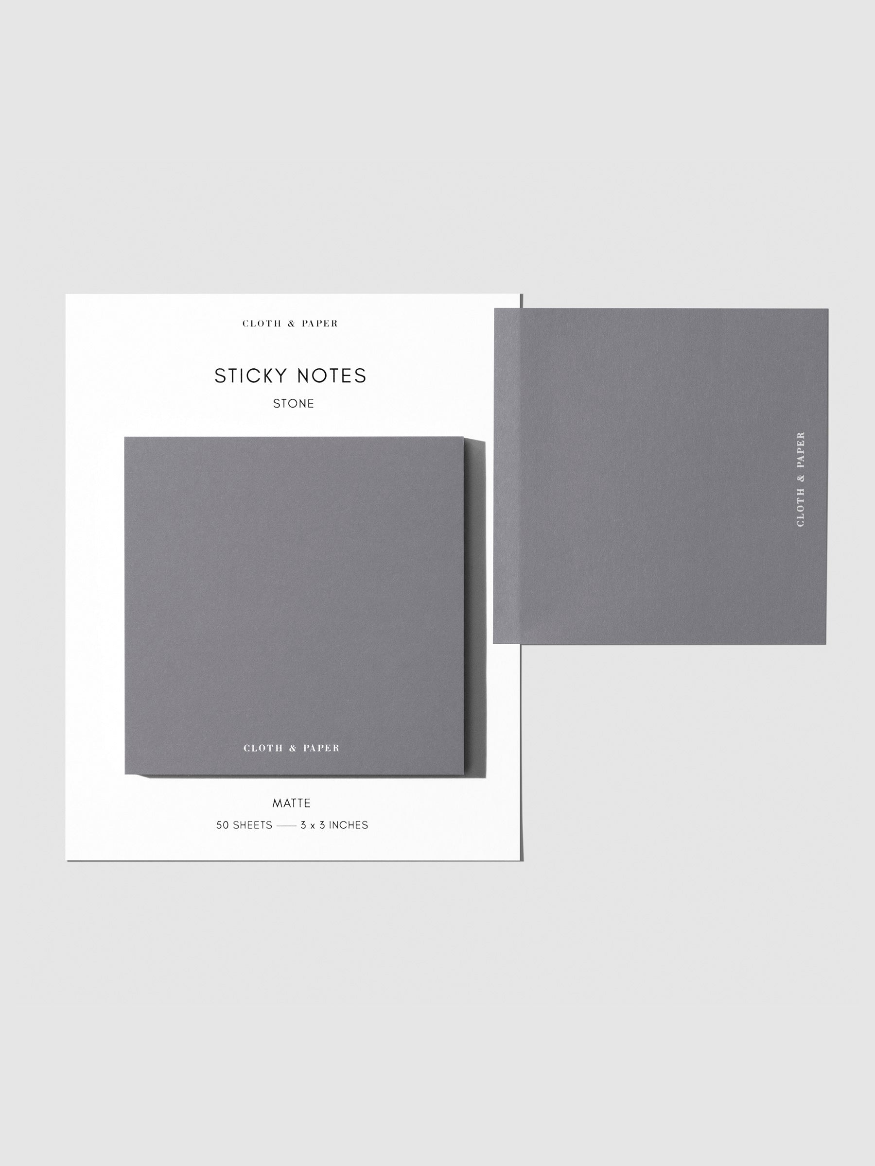 Sticky note set displayed against a neutral background. One note is placed on the packaging's edge. Color shown is Stone.