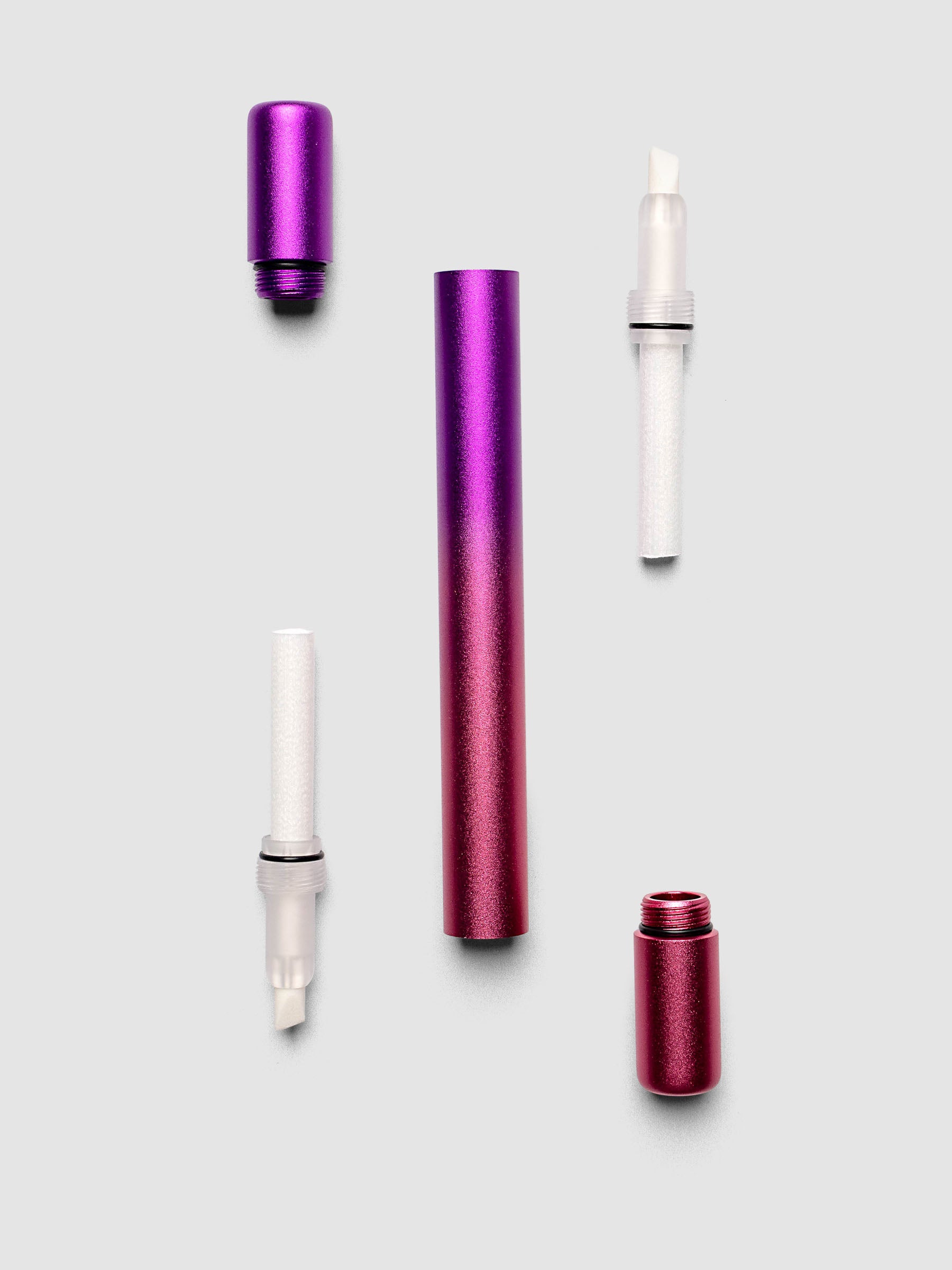 Tom's Studio Ori Refillable Highlighter disassembled into purple cap pink cap purple and pink ombre barrel and two white ink reservoirs with chisel tips