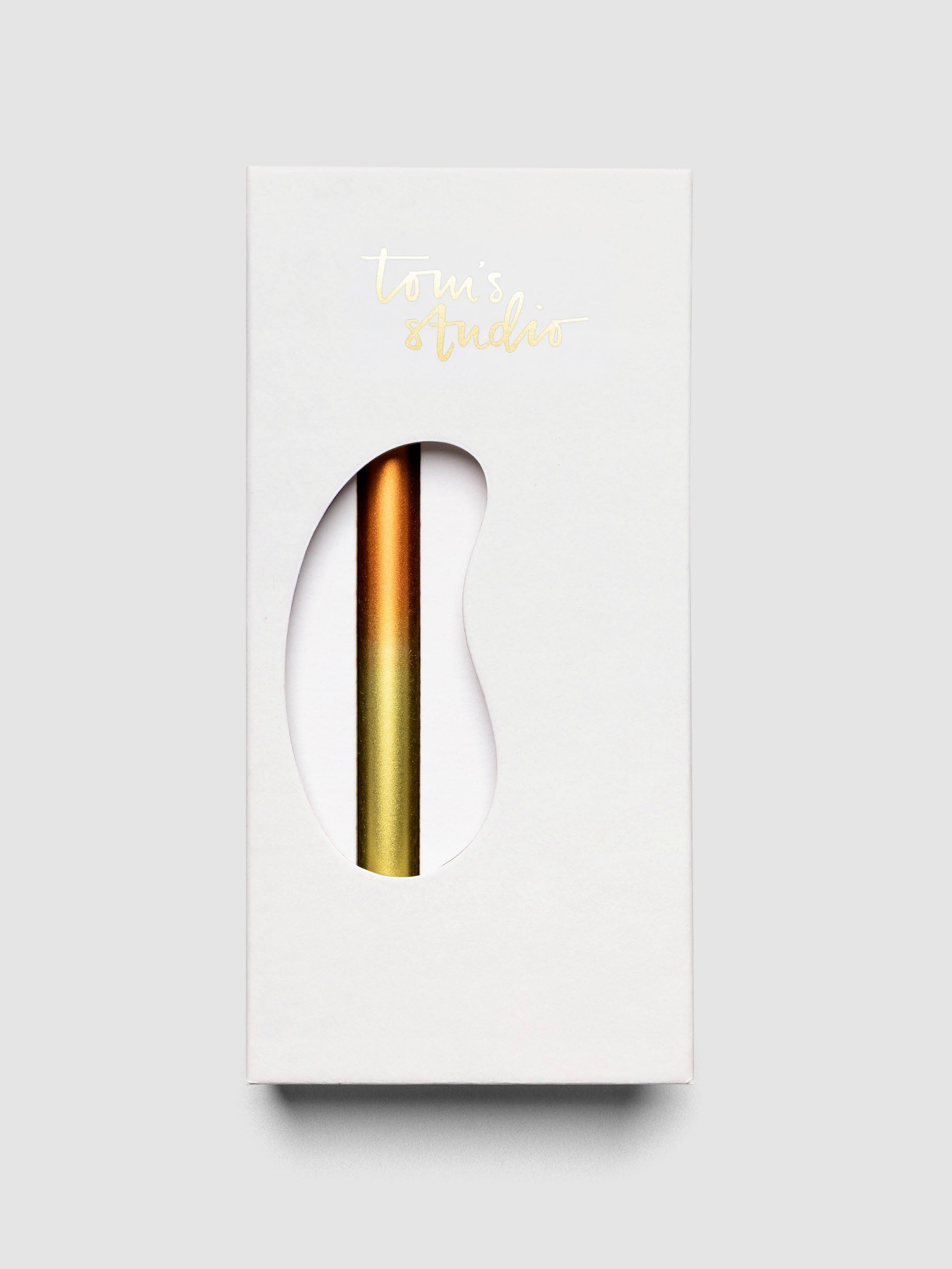 Tom's Studio Ori Refillable Highlighter in white packaging box with orange and gold ombre pen visible through cutout window
