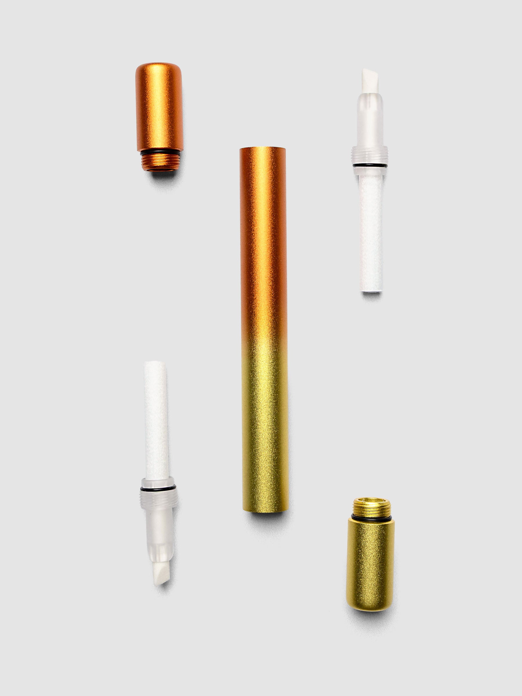 Two Tom's Studio ink bottles with gold caps and white droppers in yellow and orange