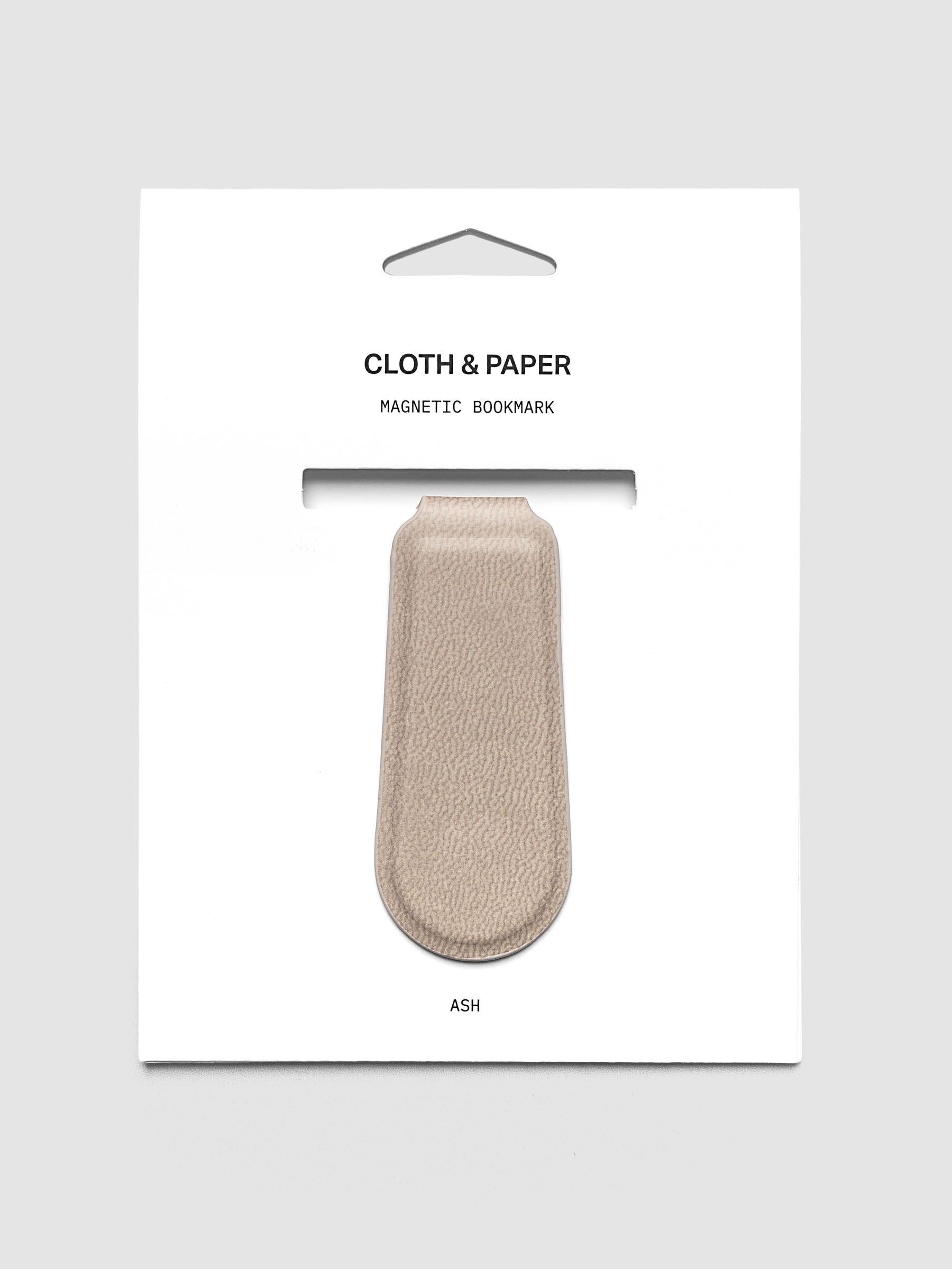 Magnetic Bookmark Smooth Leather in light taupe on retail packaging with product visible through die-cut window