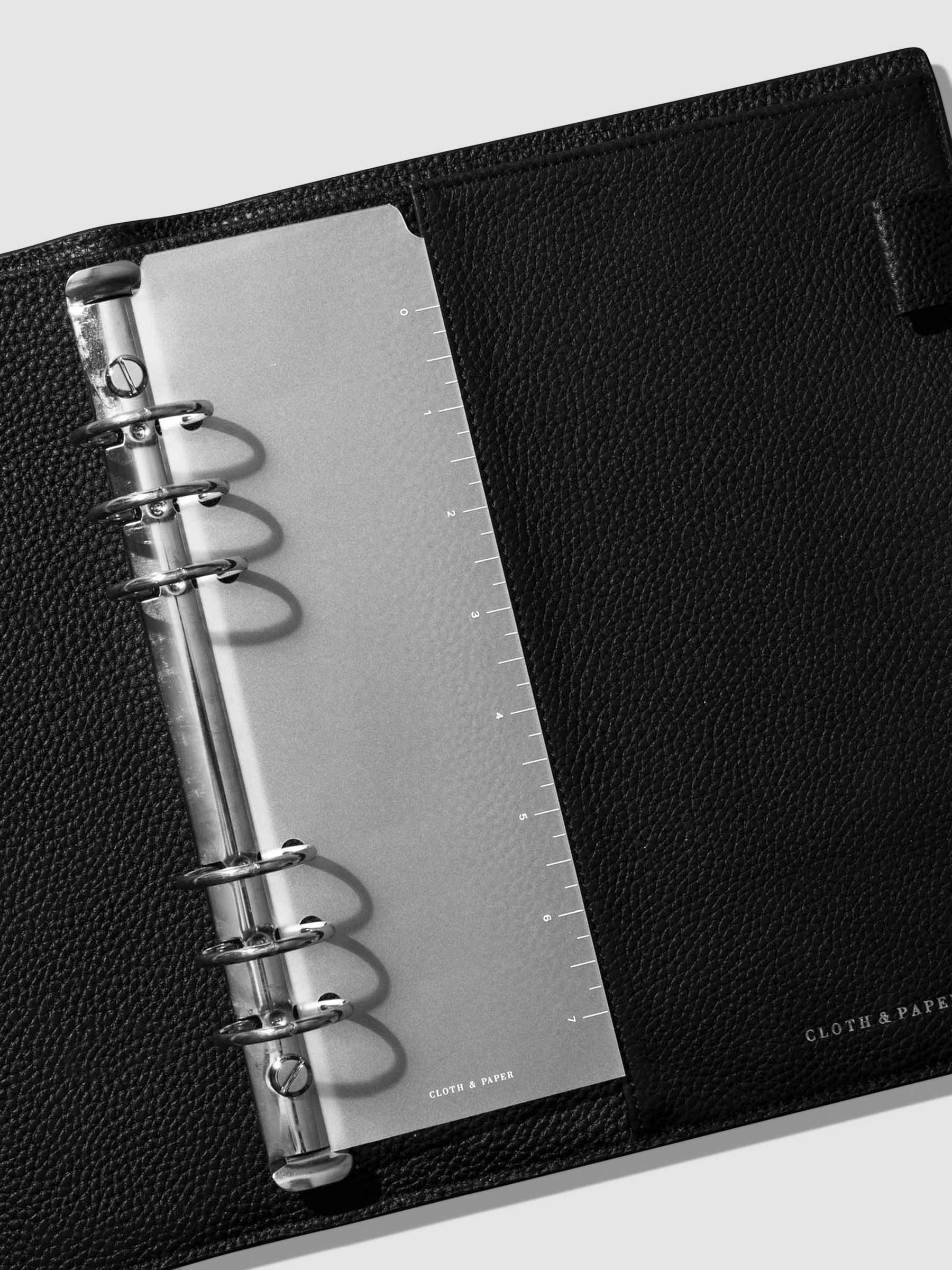 Page marker in use inside a black leather agenda.