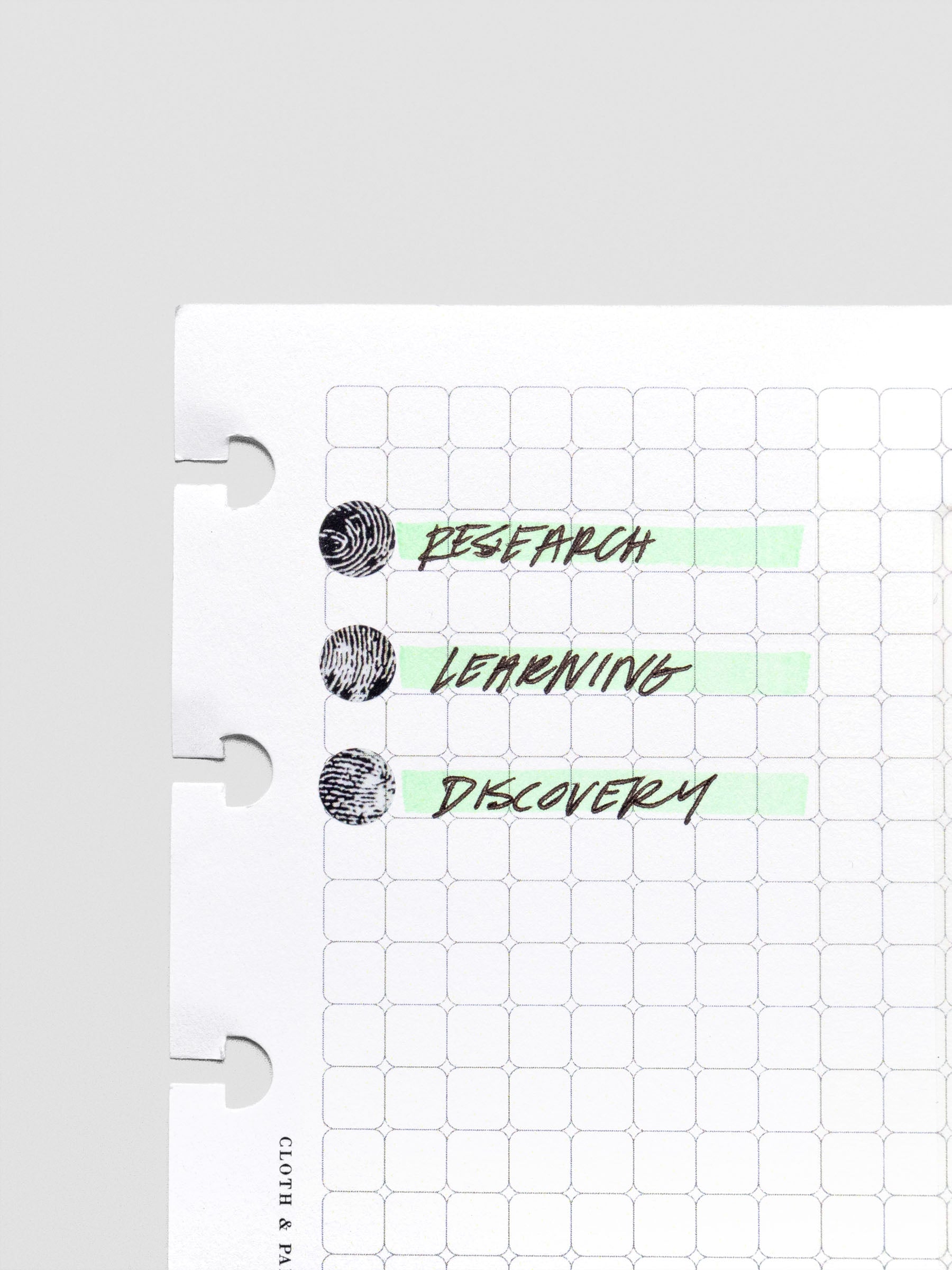 Rounded Graph Planner Insert CP Petite 6-Disc Punch open to a grid page in use with stickers, pen, and highlighter
