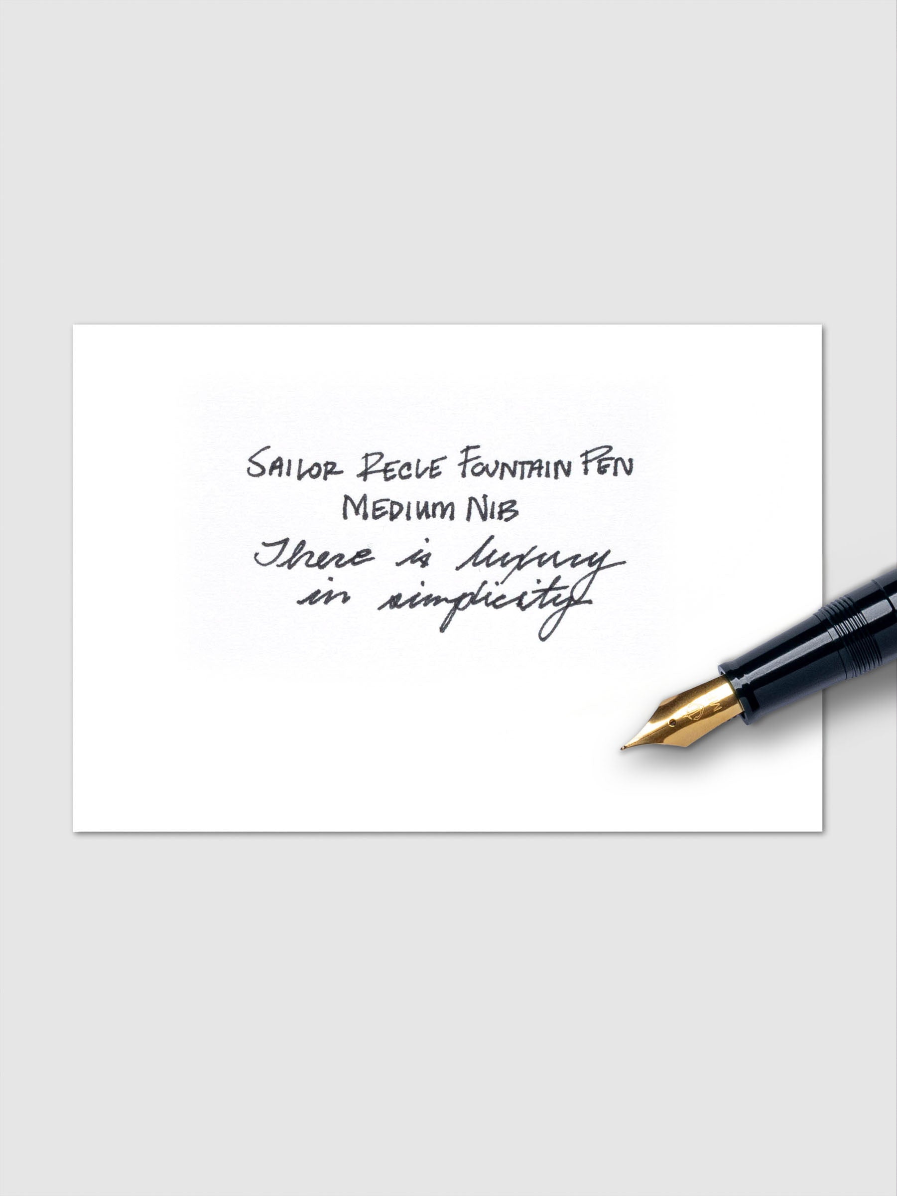 Sailor Recle Fountain Pen Medium in Teal Green uncapped, angled on white surface.