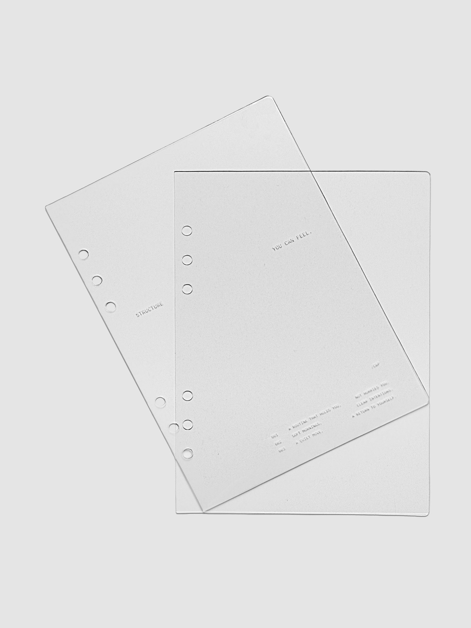 A5 sized crystal clear plastic planner cover set with text printed on the cover on the theme of structure and routines.