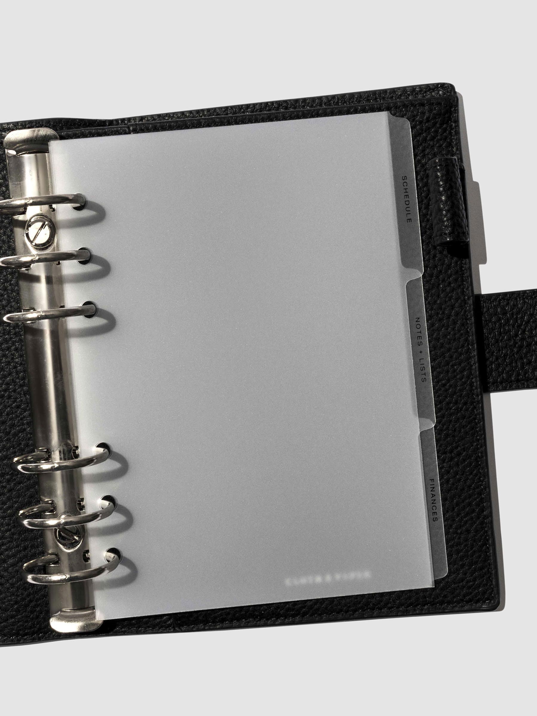 Black foil tabs displayed in use inside a  leather folio.