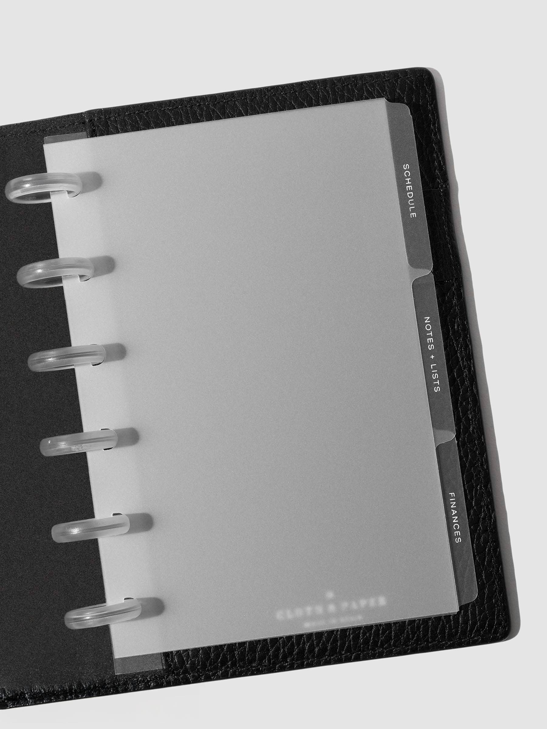 White foil tabs displayed in use inside a  leather folio.