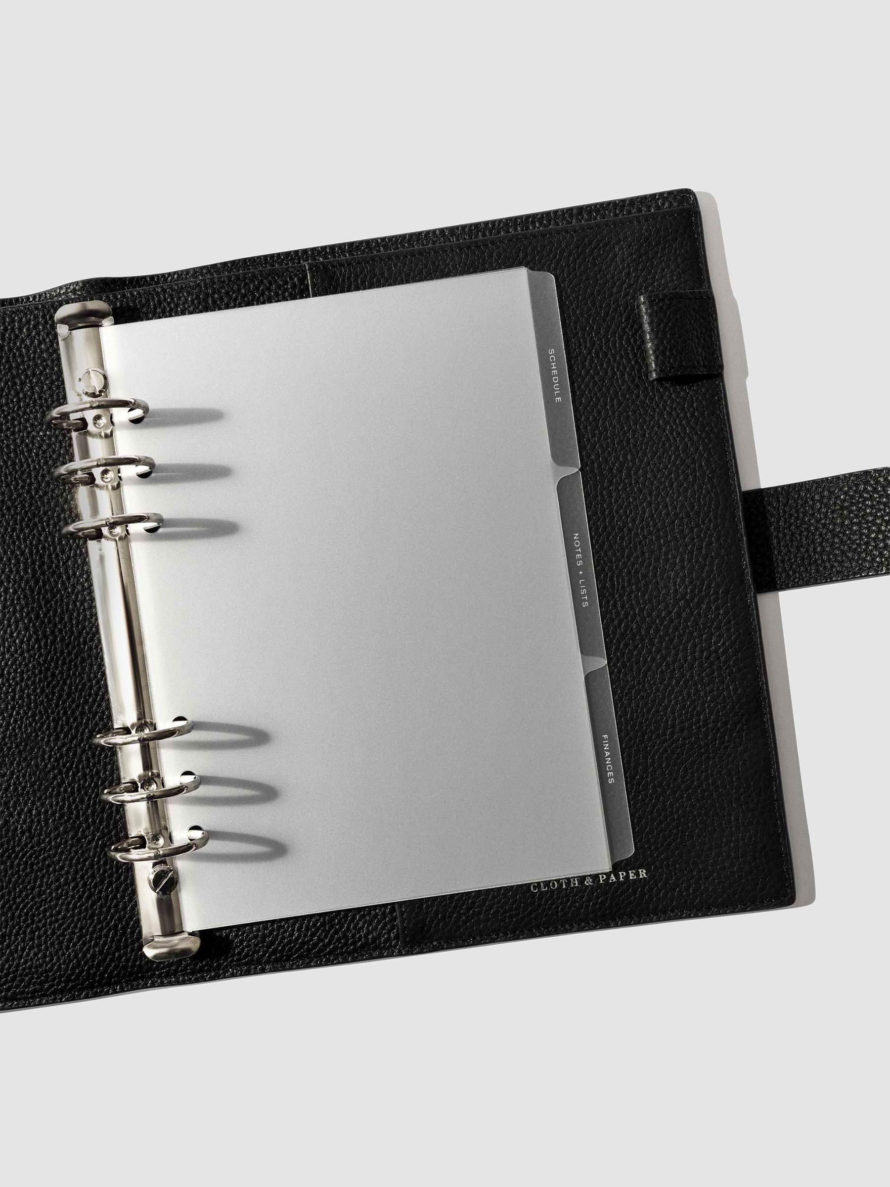 White foil tabs displayed in use inside a  leather folio.