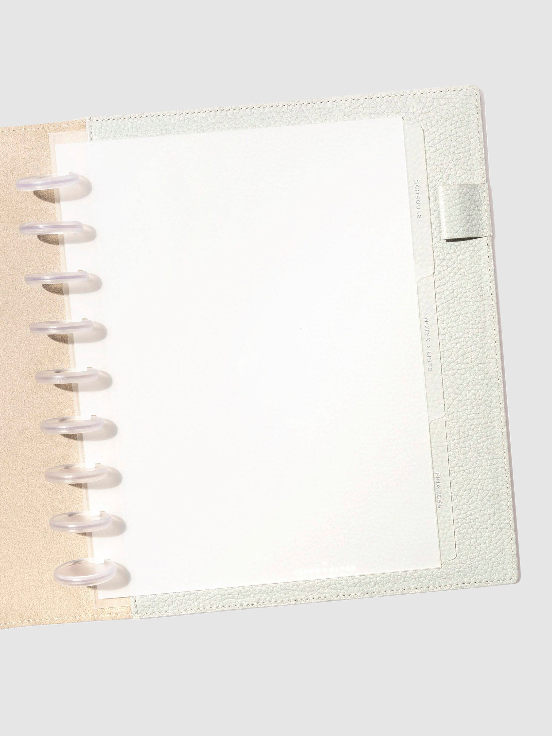 White foil tabs displayed in use inside a  leather folio.