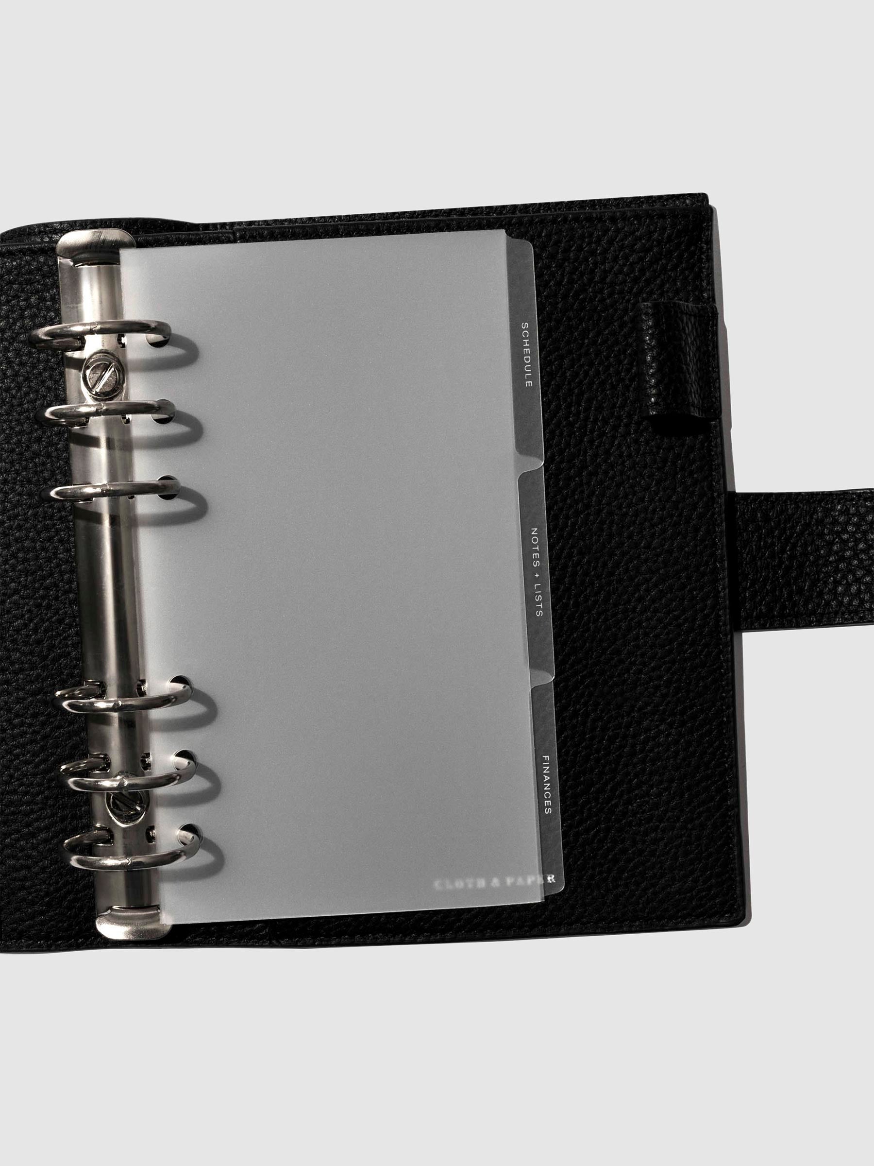 White foil tabs displayed in use inside a  leather folio.