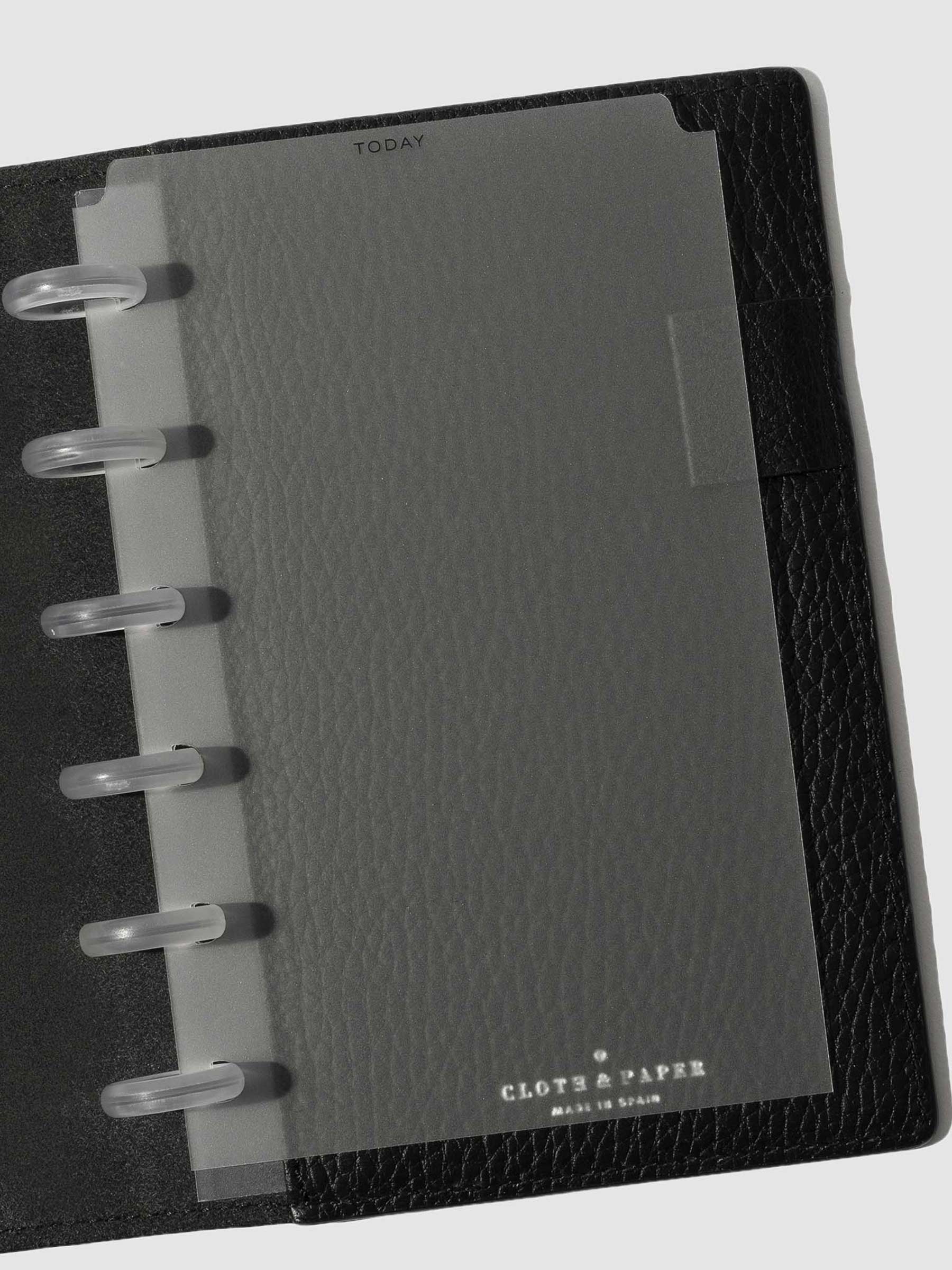 Black foil divider displayed in a black leather planner.
