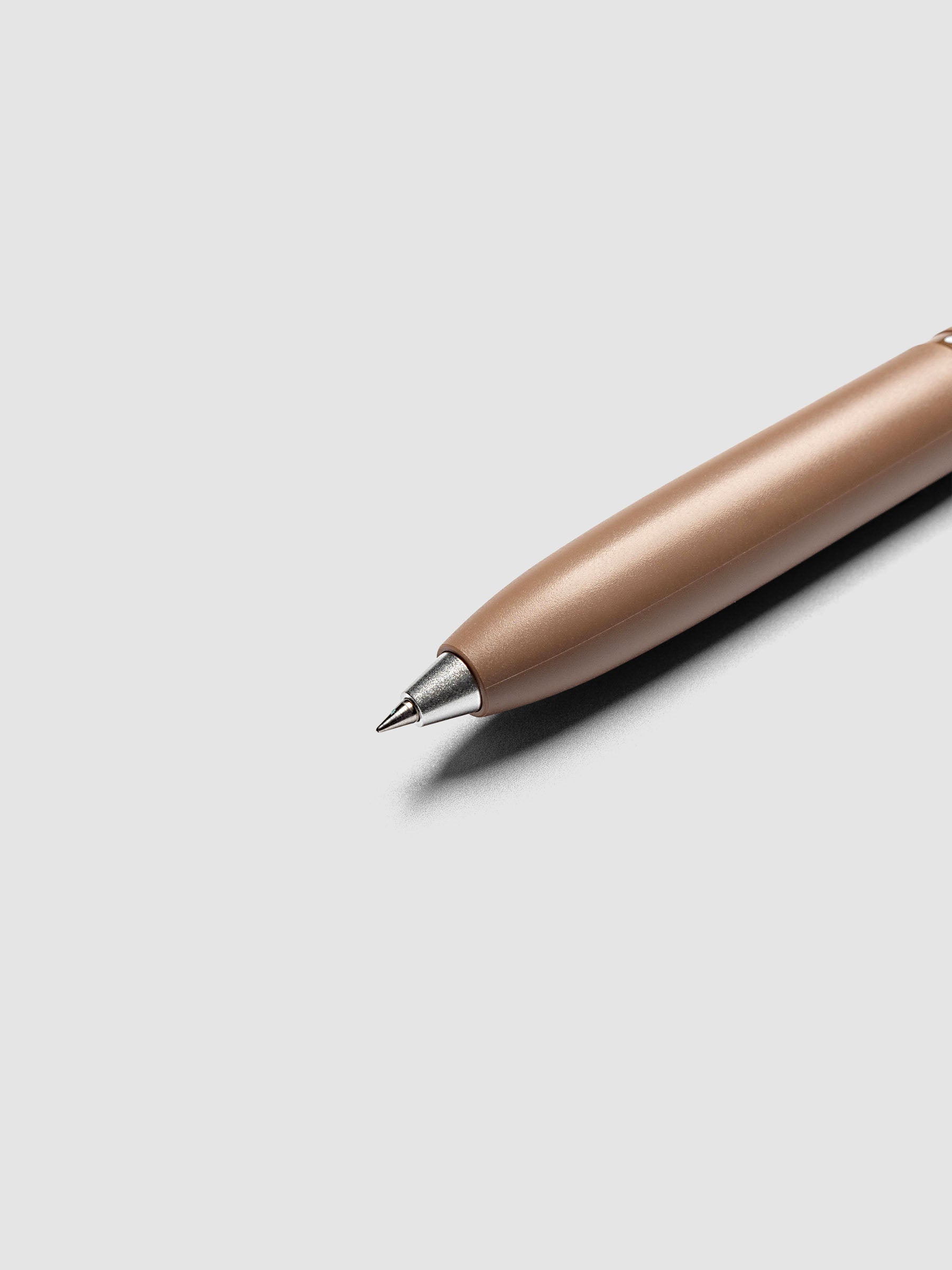 Uni-ball One 3-Color Ballpoint Pen in brown close up of silver metal tip