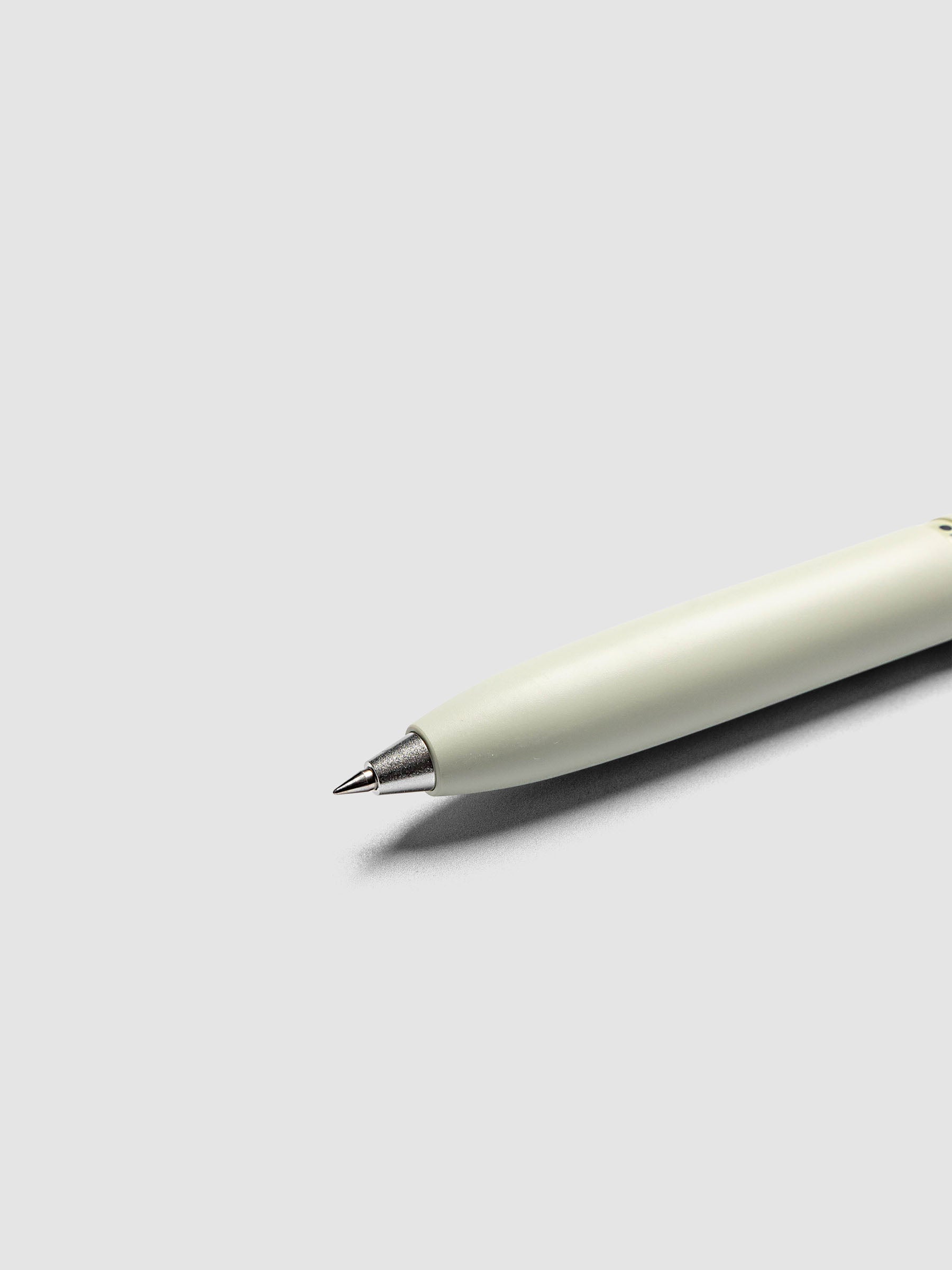 Uni-ball One 3-Color Ballpoint Pen in pale sage green close up of silver metal tip