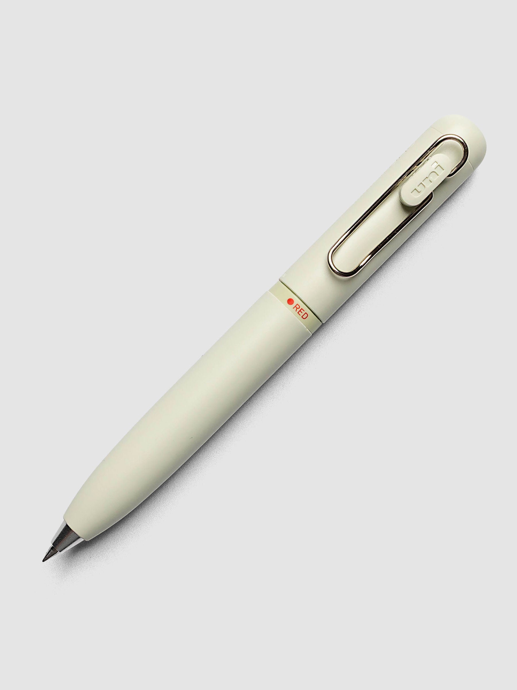 Uni-ball One 3-Color Ballpoint Pen in pale sage green close up of barrel showing RED color indicator
