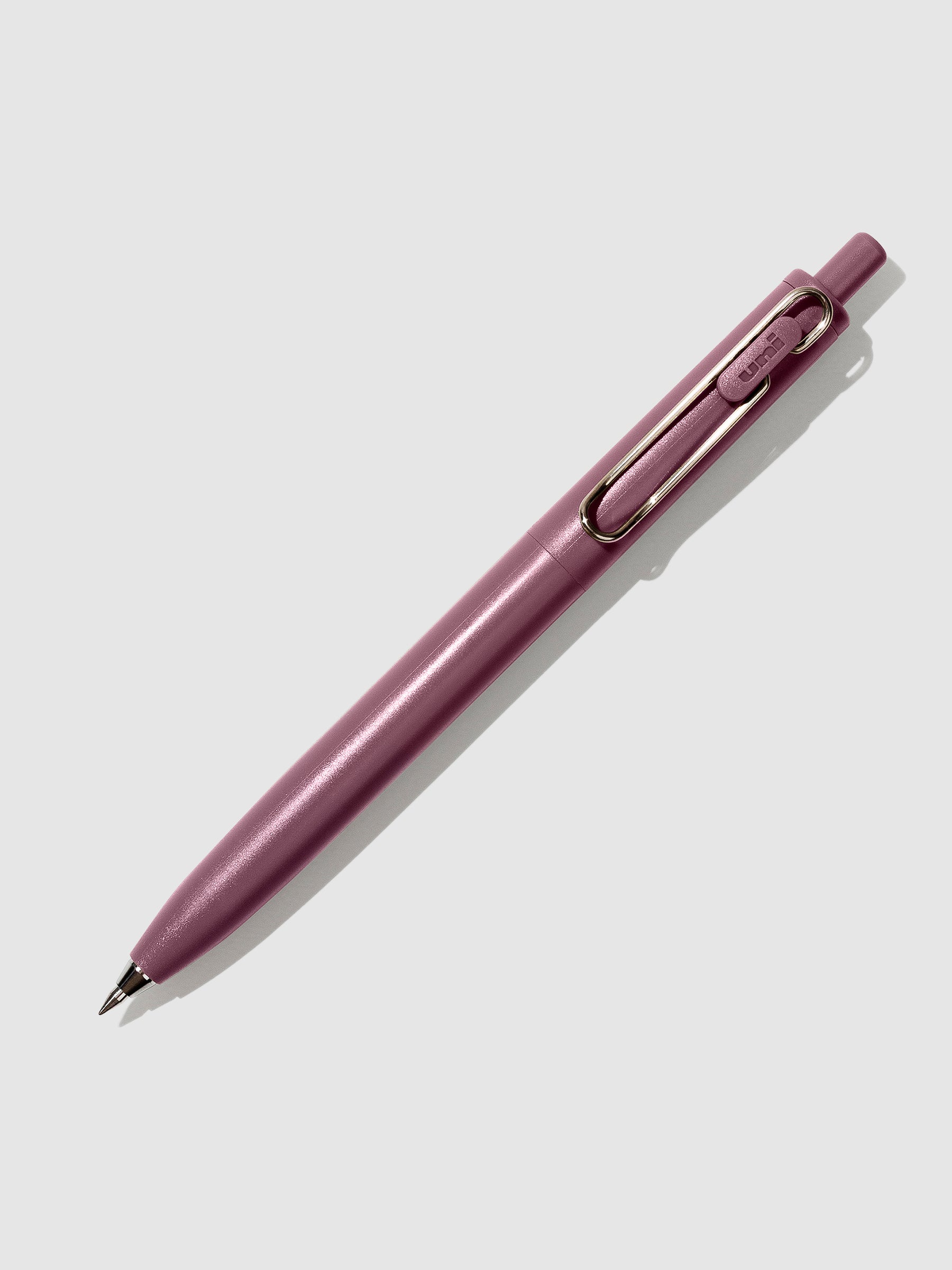Cherry pen turned to the right against a neutral background.