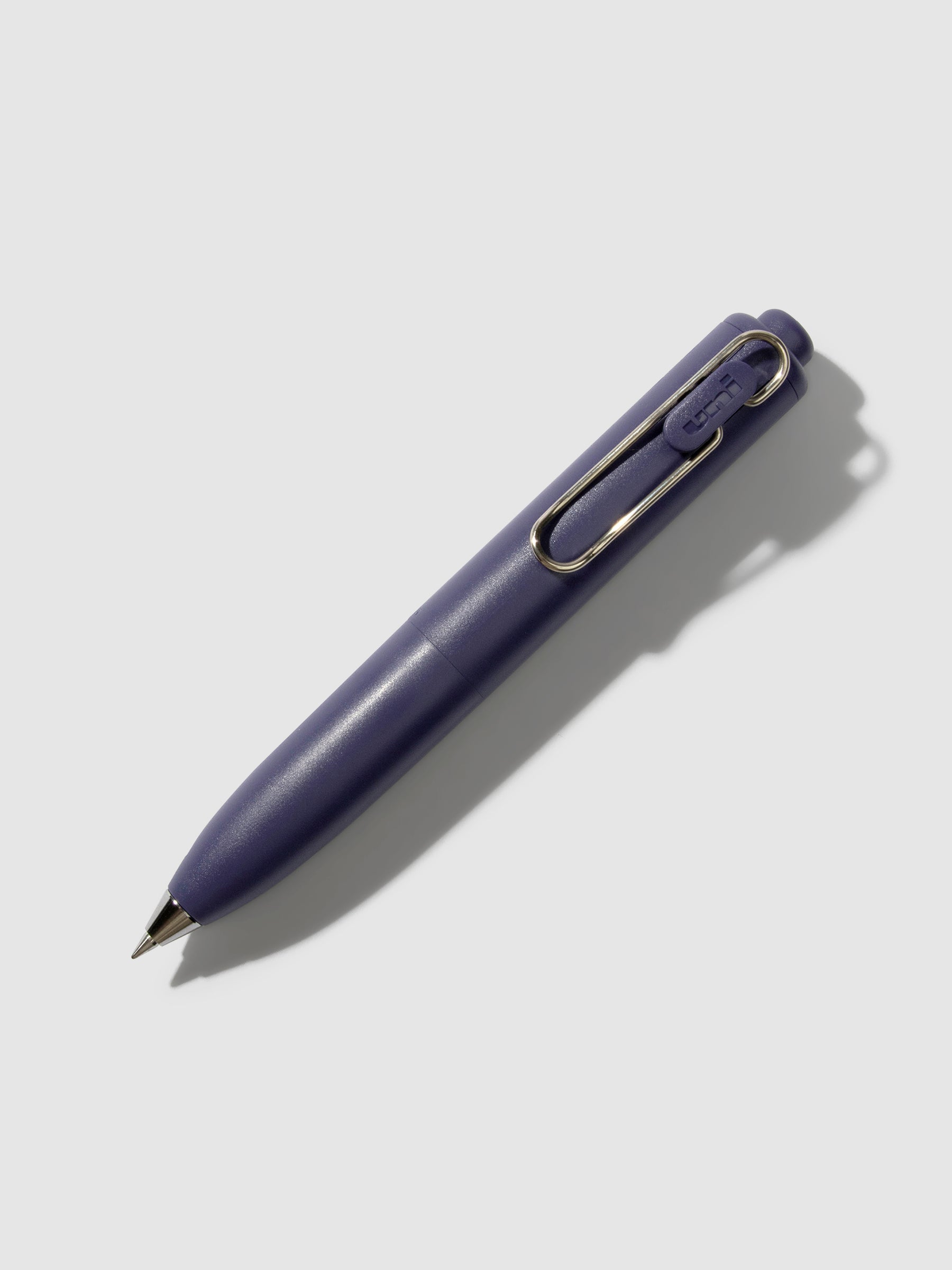 Uni-Ball One P Gel Pen, Cloth and Paper. Pen turned to the right on a neutral background. Color pictured is Grape.