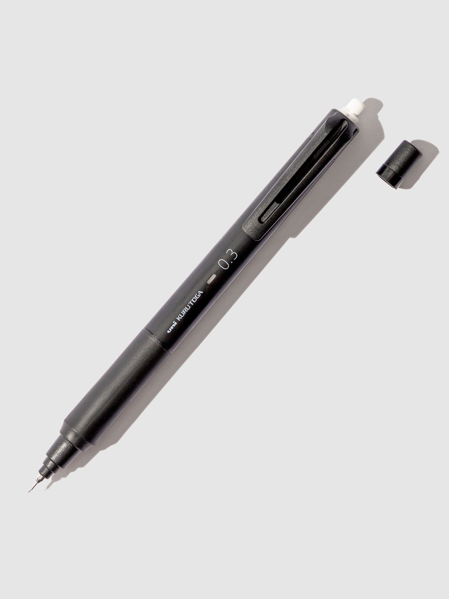 Uni Kuru Toga KS Mechanical Pencil, Cloth and Paper. Black pencil displayed on a neutral background. 