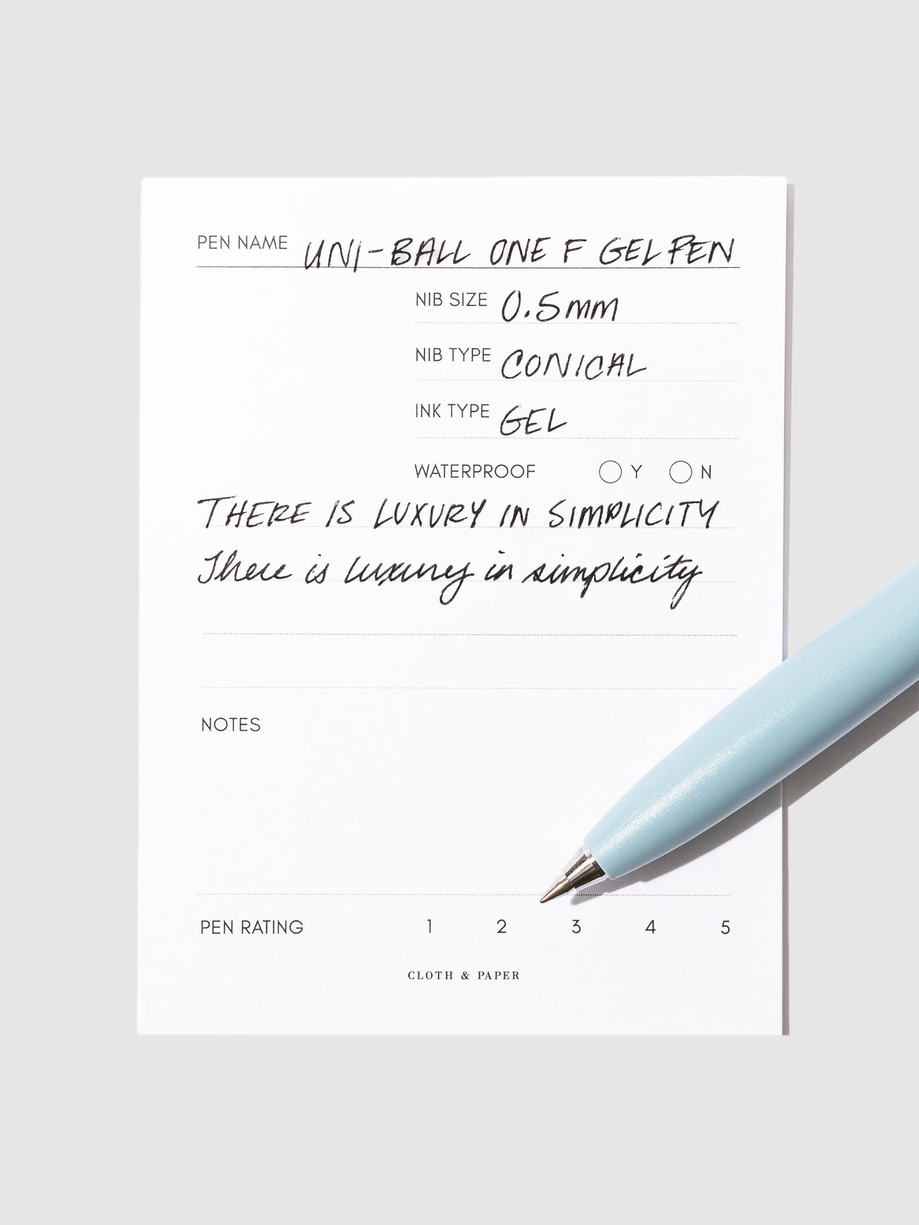 Blue  pen resting on an in use pen test sheet.