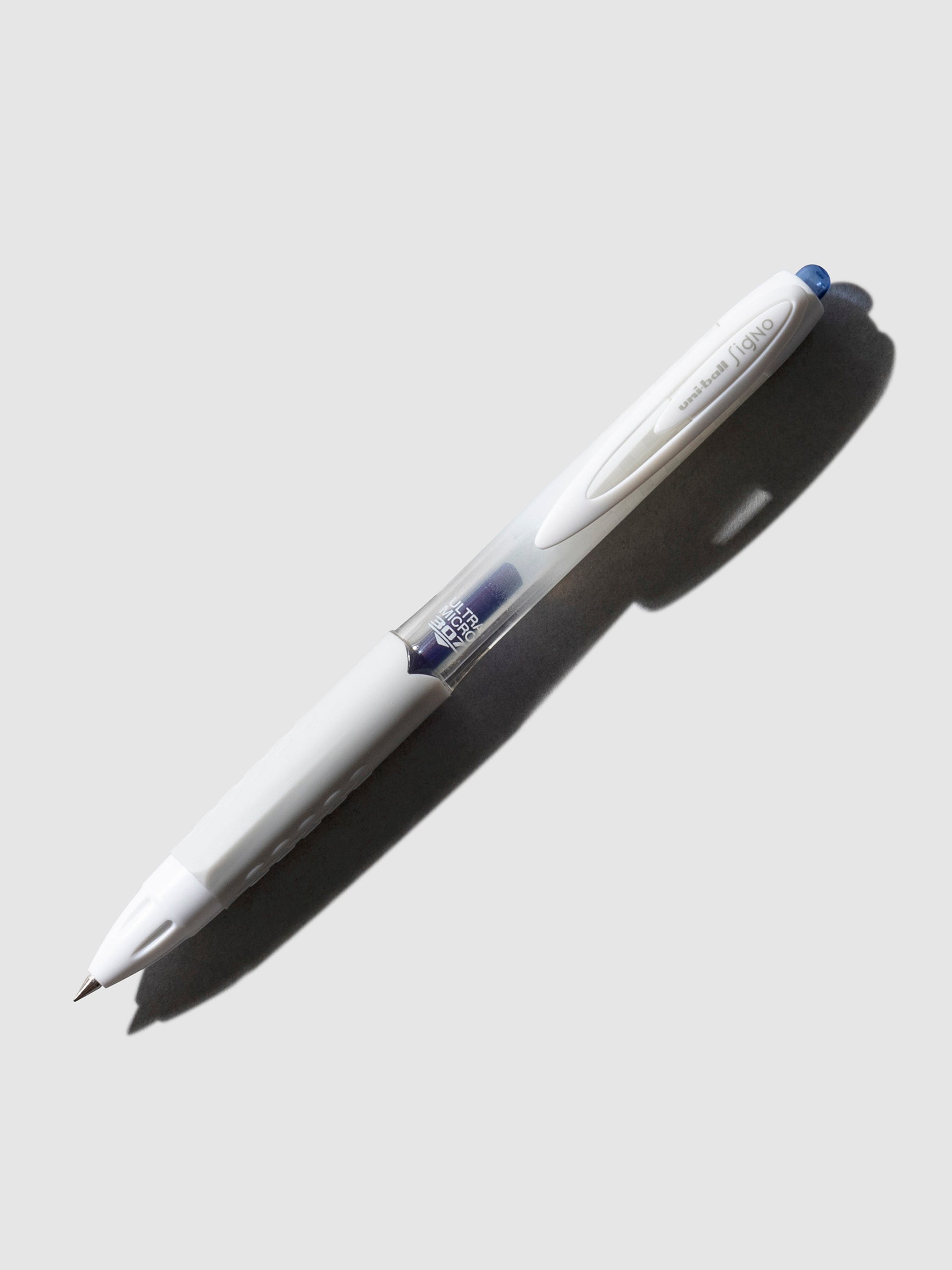 Uni-Ball Signo Gel Pen, 0.38 mm, blue, Cloth and Paper. Gel pen tilted slightly to the right on a neutral background.
