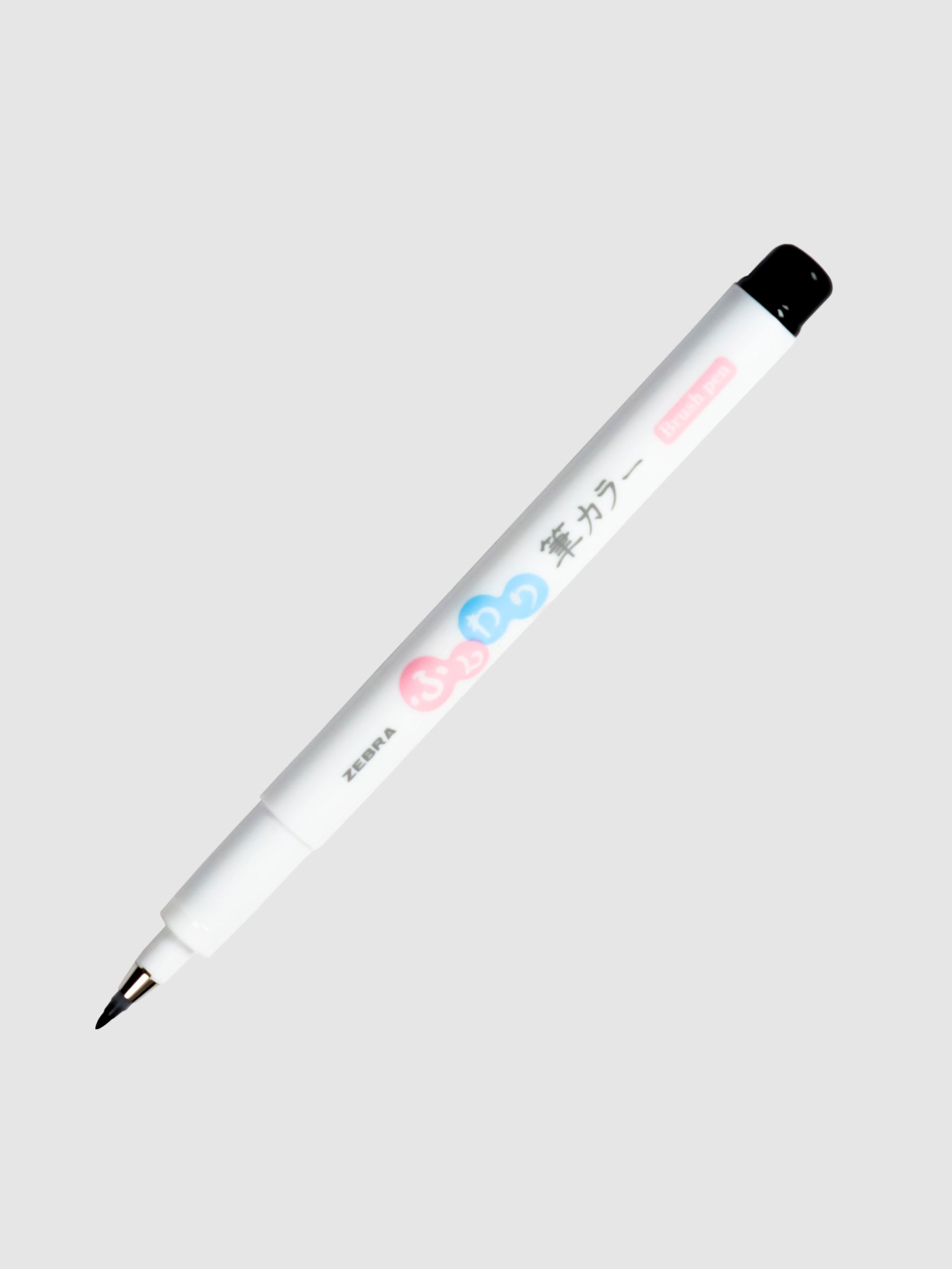 Zebra Funwari Brush Pen with cap removed, turned to the left against a neutral background.