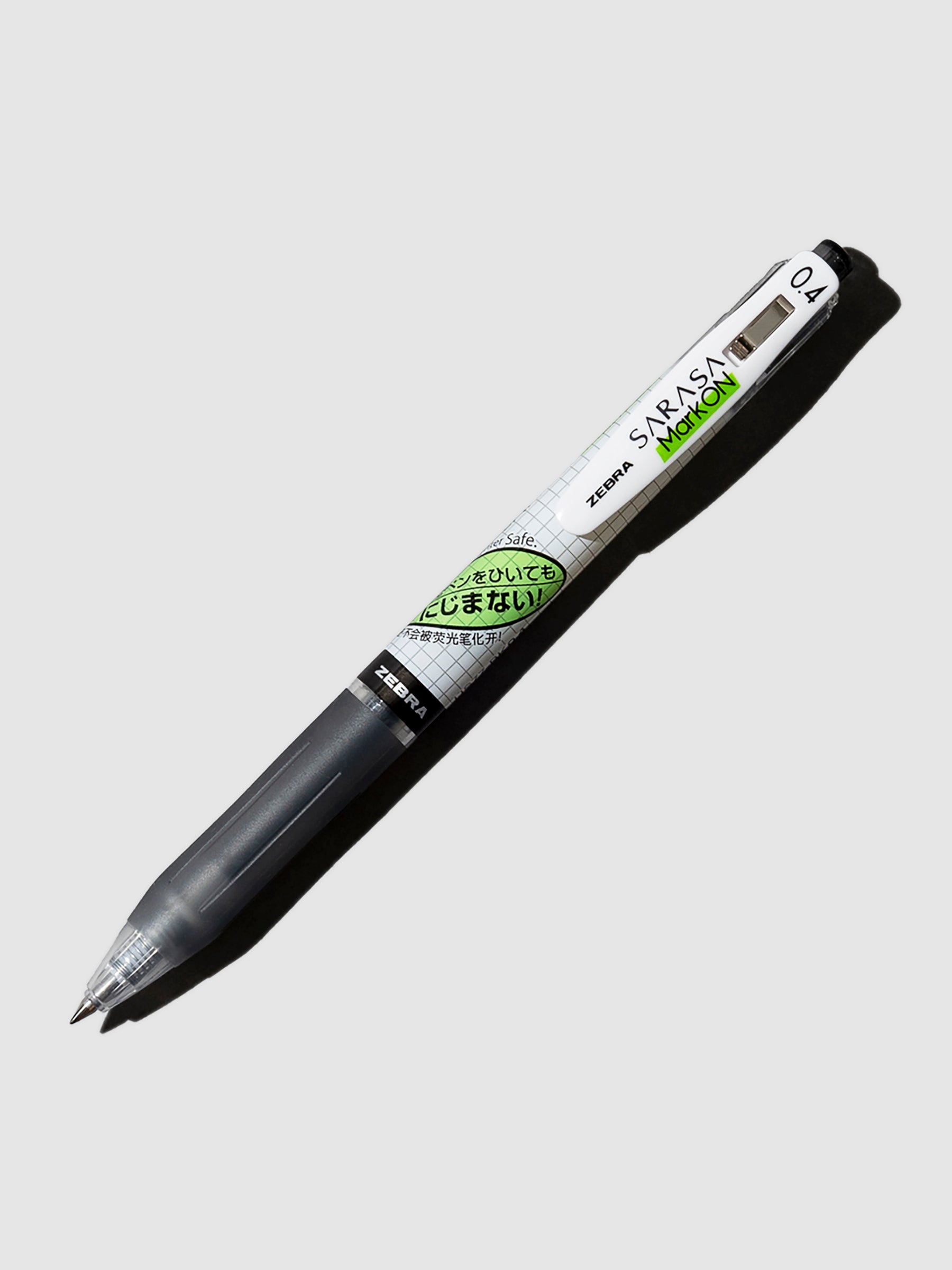 Zebra Sarasa Mark ON Pen in 0.4 mm with black ink turned to the right against a neutral background.