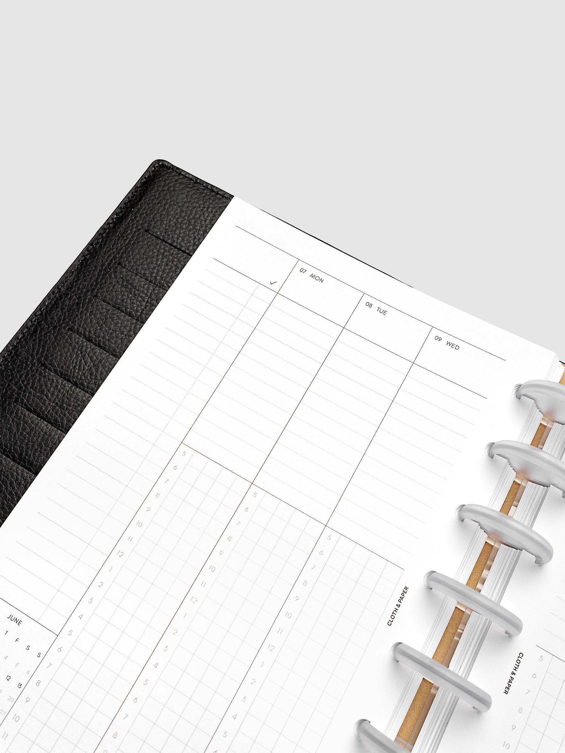 Half Letter 8-Disc Punch left page detail showing time blocking grid in a planner