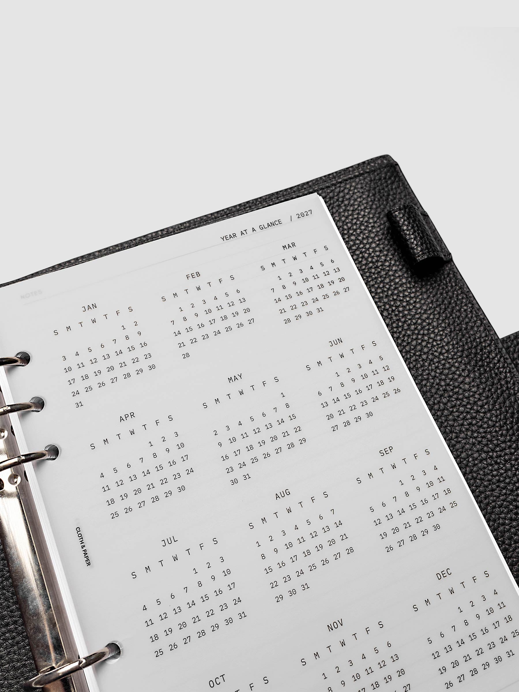 2027 Year At A Glance Dashboard Sunday Start, A5 6-Ring Punch, close-up of the top of the vellum dashboard showing the first months of the 2027 year-at-a-glance calendar in Sunday-start format